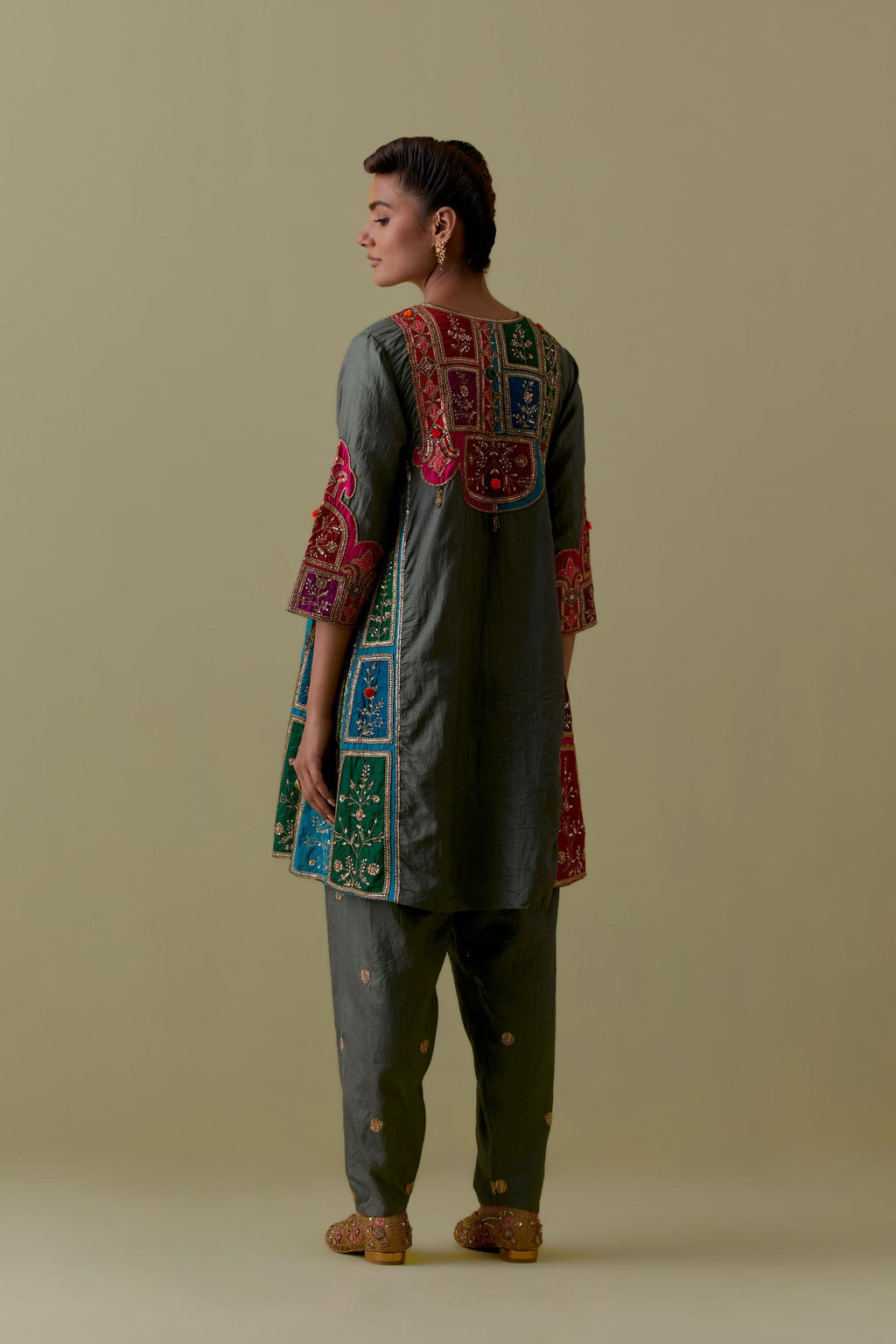 Green Silk Kalidar Kurta with Multicoloured Appliqué. Paired with green Silk Salwar with Gold seuins and bead Handwork