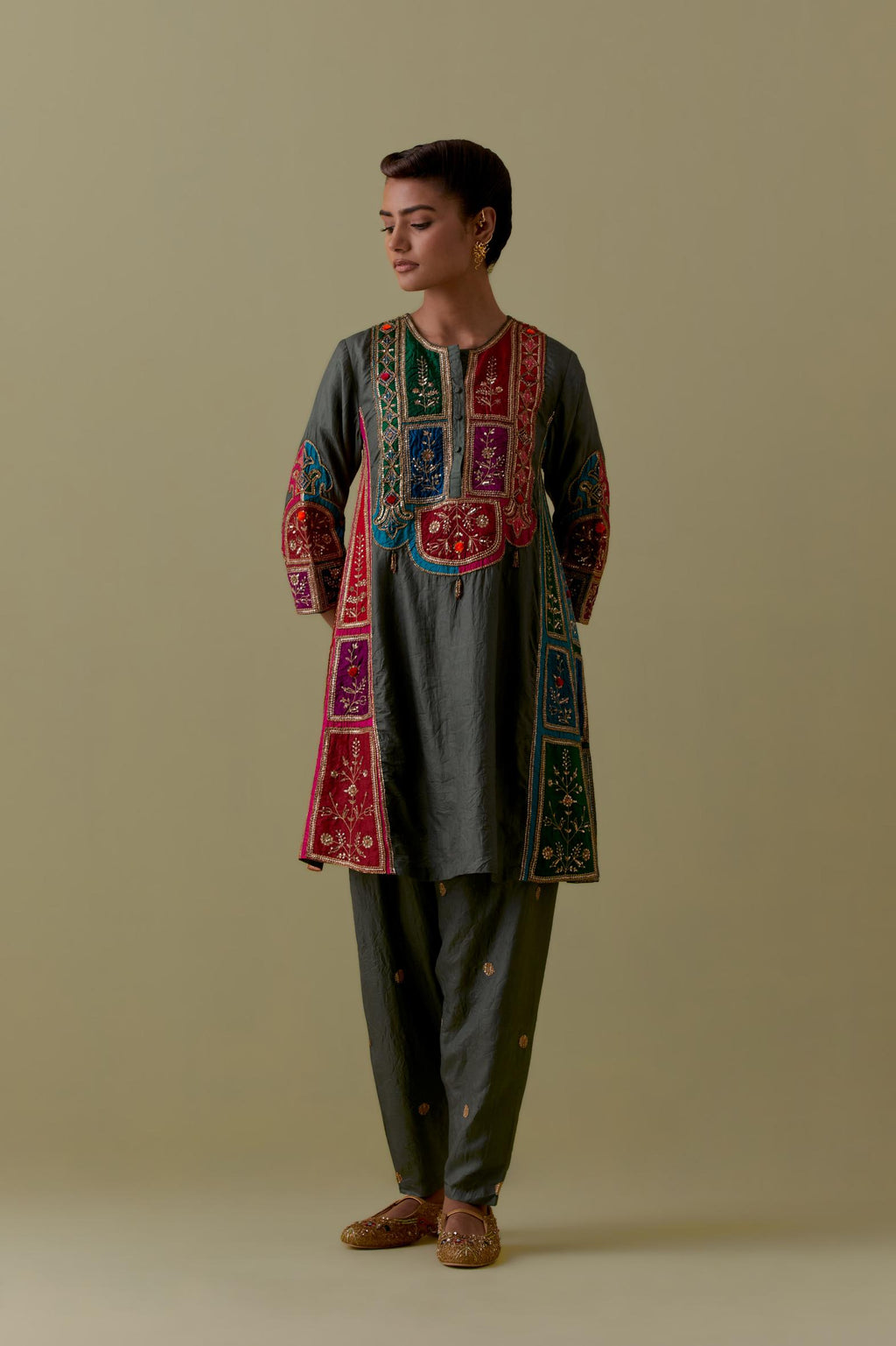 Green Silk Kalidar Kurta with Multicoloured Appliqué. Paired with green Silk Salwar with Gold seuins and bead Handwork