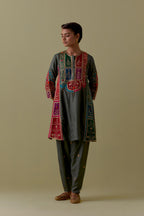Green Silk Kalidar Kurta with Multicoloured Appliqué. Paired with green Silk Salwar with Gold seuins and bead Handwork