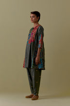 Green Silk Kalidar Kurta with Multicoloured Appliqué. Paired with green Silk Salwar with Gold seuins and bead Handwork