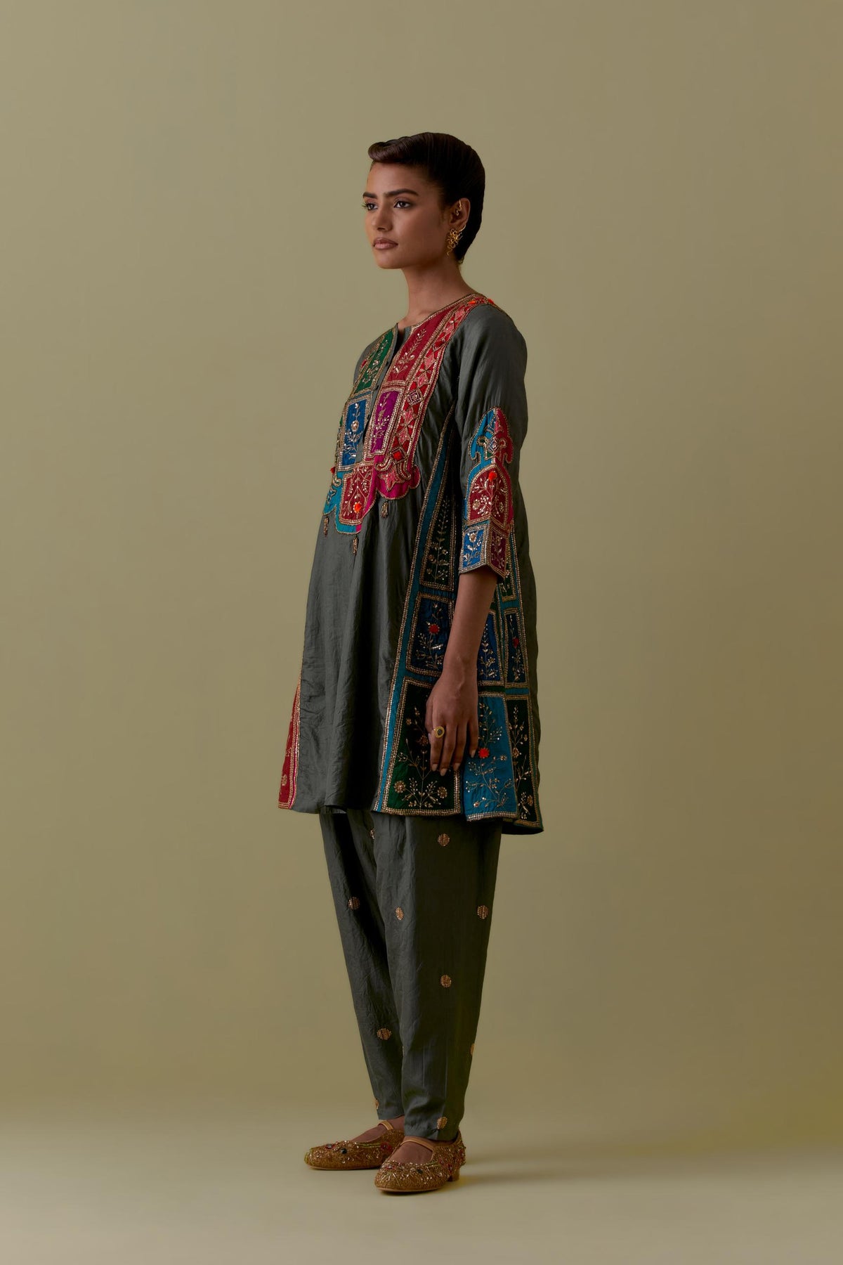 Green Silk Kalidar Kurta with Multicoloured Appliqué. Paired with green Silk Salwar with Gold seuins and bead Handwork