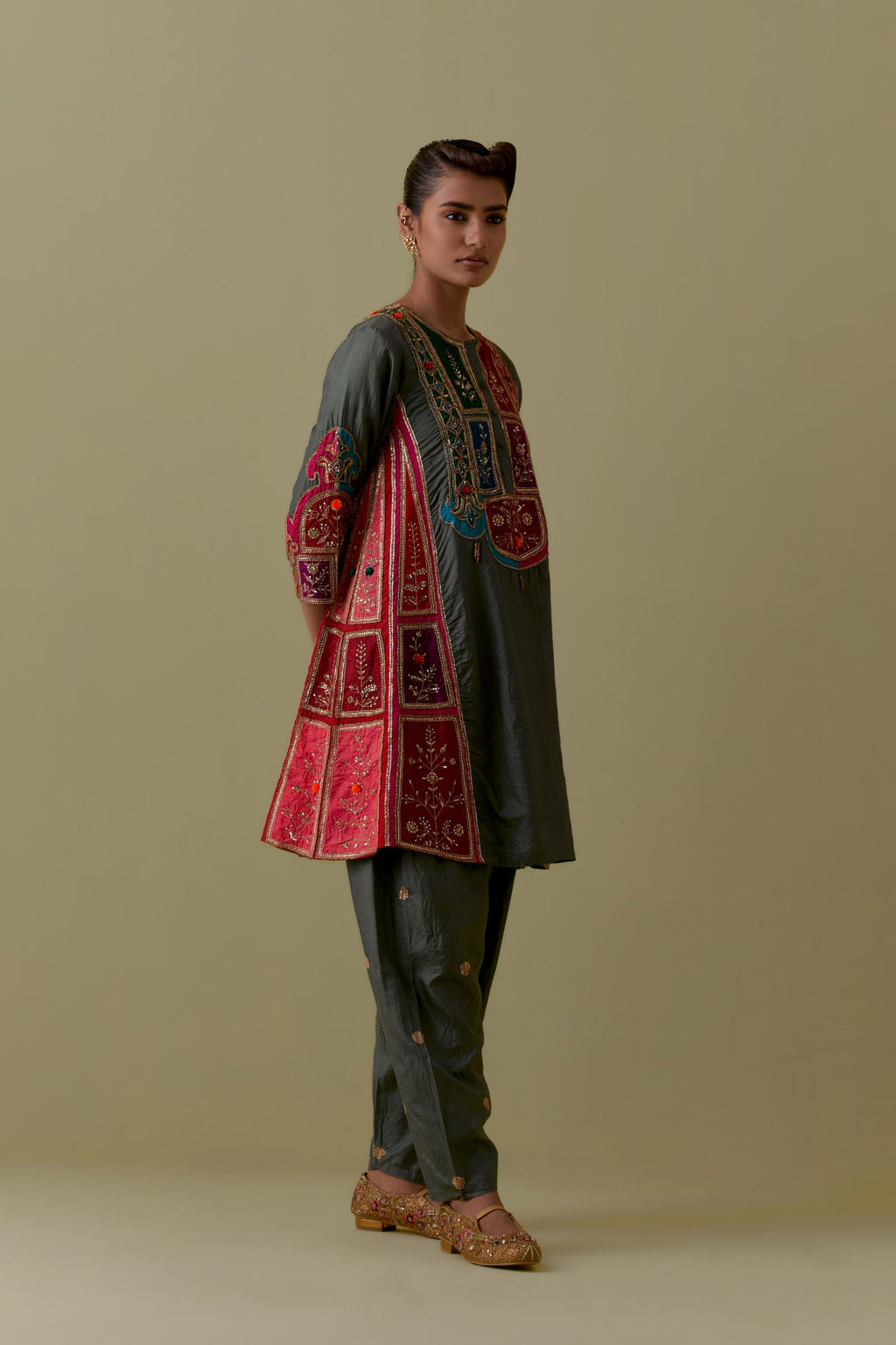 Green Silk Kalidar Kurta with Multicoloured Appliqué. Paired with green Silk Salwar with Gold seuins and bead Handwork