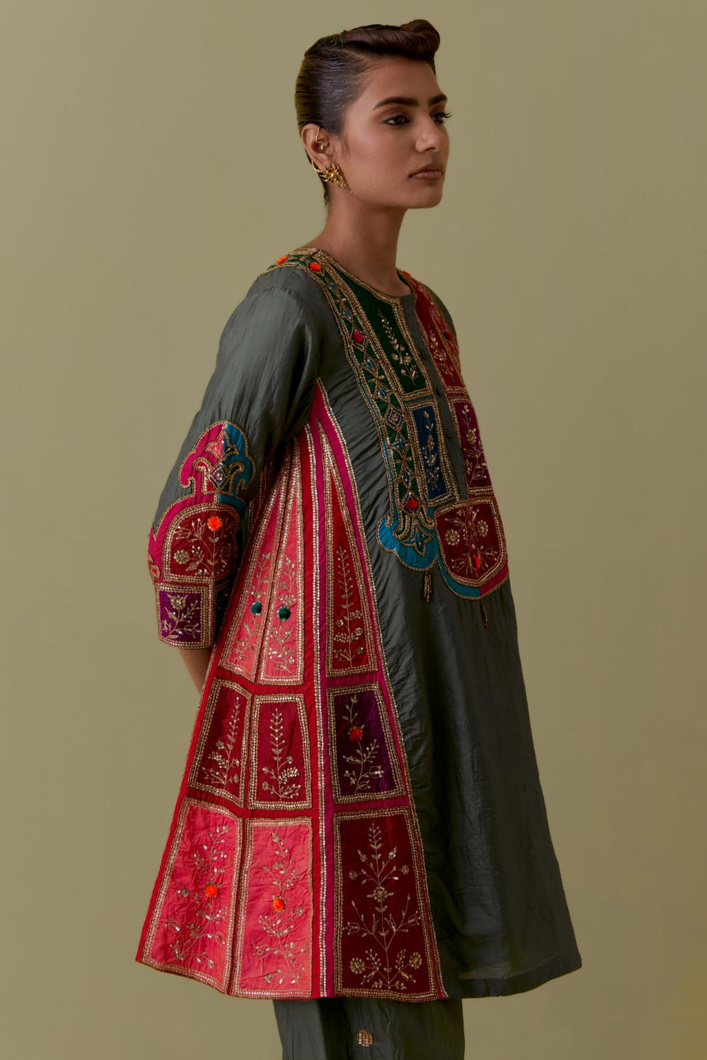 Green Silk Kalidar Kurta with Multicoloured Appliqué. Paired with green Silk Salwar with Gold seuins and bead Handwork