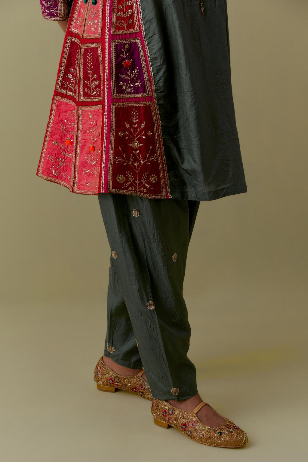 Green Silk Kalidar Kurta with Multicoloured Appliqué. Paired with green Silk Salwar with Gold seuins and bead Handwork