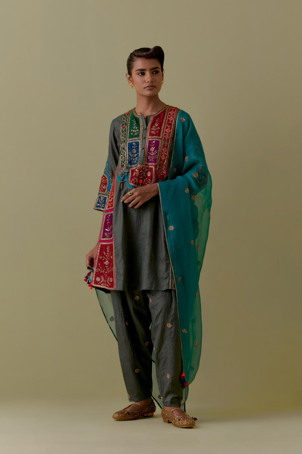 Green Silk Kalidar Kurta with Multicoloured Appliqué. Paired with green Silk Salwar with Gold seuins and bead Handwork