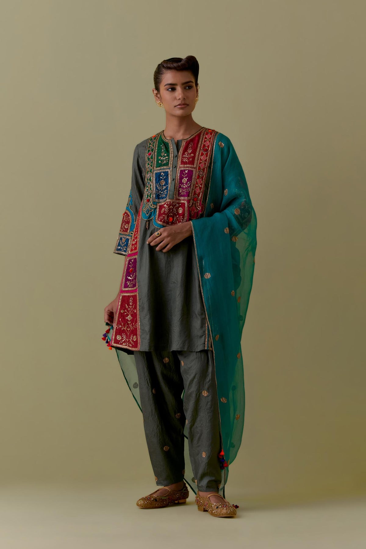 Green Silk Kalidar Kurta with Multicoloured Appliqué. Paired with green Silk Salwar with Gold seuins and bead Handwork