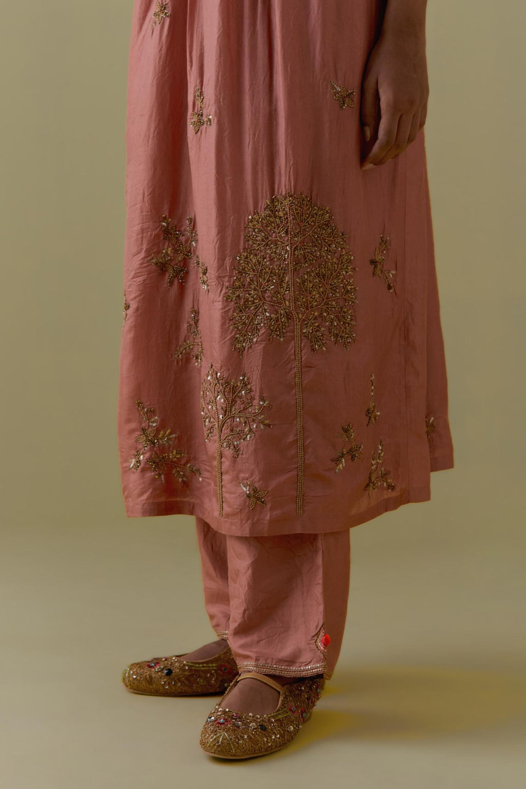 Peach silk Kurta set with hand worked Floral & Tree Motifs.