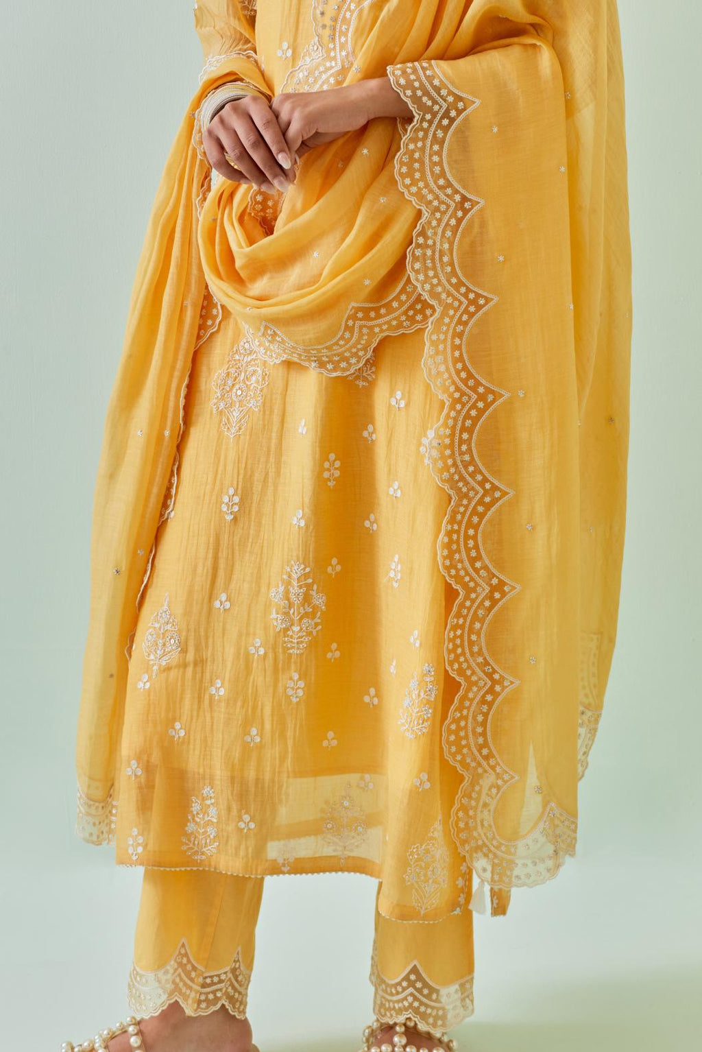 Yellow cotton chanderi dupatta with scalloped and embroidered edges.