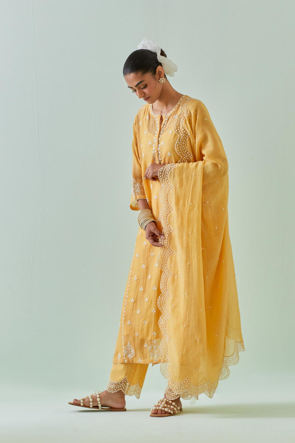 Yellow straight kurta set with all-over off white Dori embroidery, highlighted with delicate beaded work and embroidery detail at side panel joint seams.