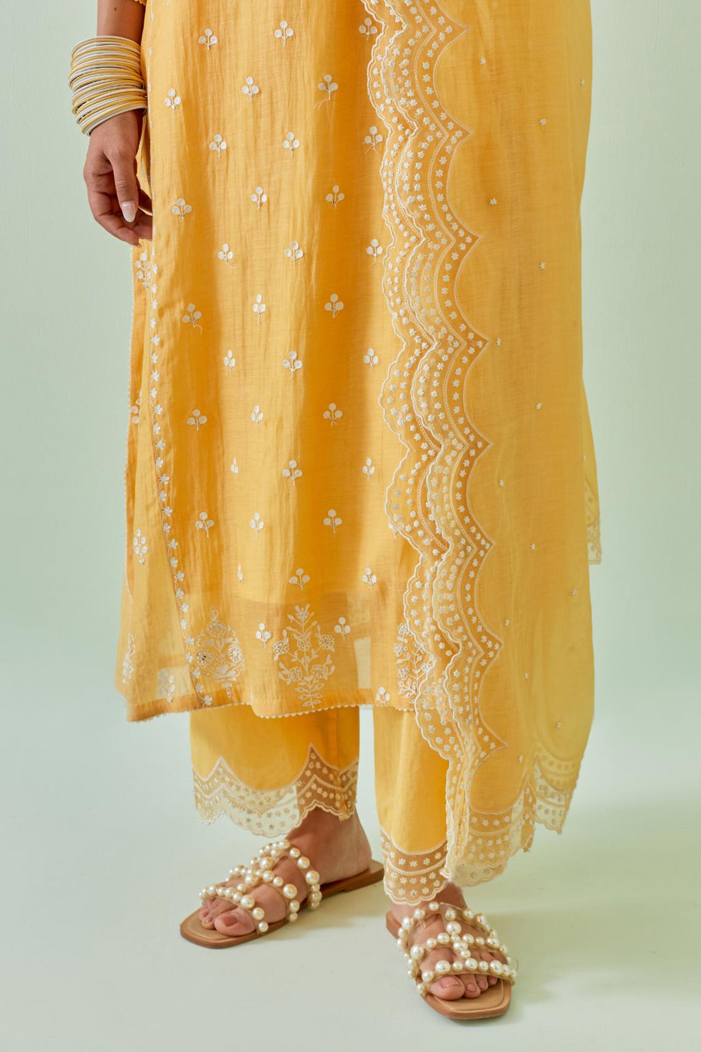 Yellow straight kurta set with all-over off white Dori embroidery, highlighted with delicate beaded work and embroidery detail at side panel joint seams.