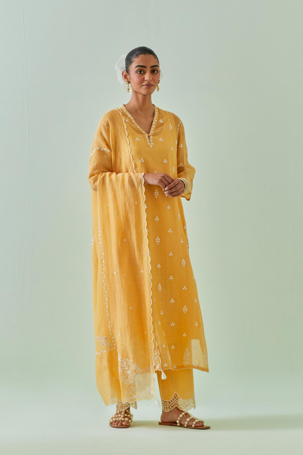 Yellow cotton chanderi dupatta with all-over off white embroidery and scalloped edges.