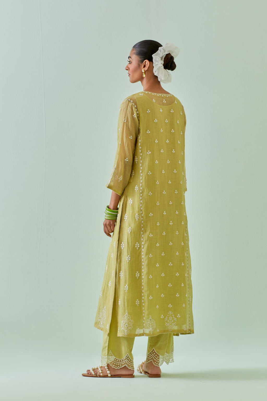 Green straight kurta set with all-over off white Dori embroidery, highlighted with delicate beaded work and embroidery detail at side panel joint seams.