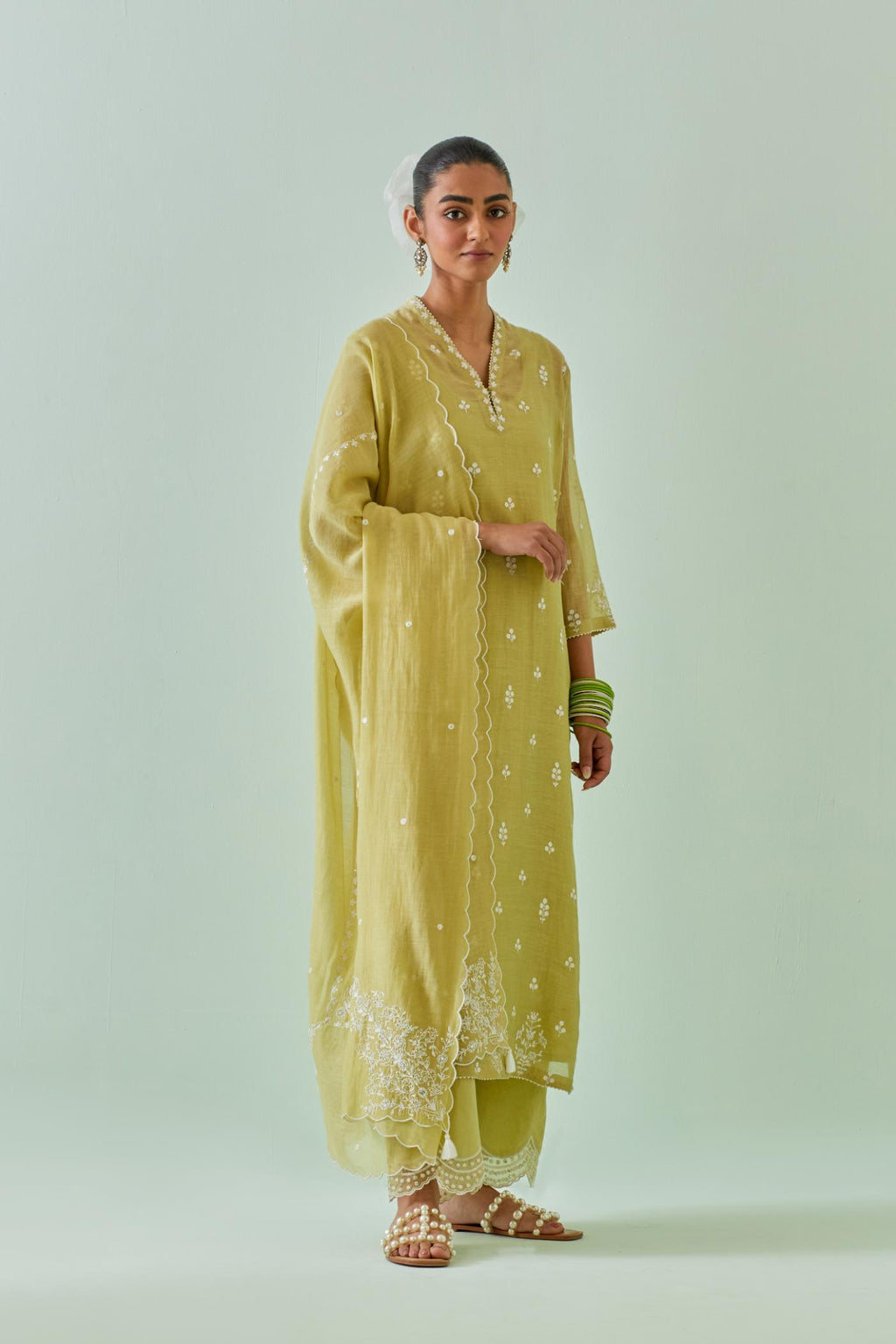 Green cotton chanderi dupatta with all-over off white embroidery and scalloped edges.