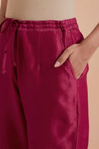 Fuchsia silk chanderi straight pants detailed with scalloped organza edging at the hem, delicately highlighted with gold zari quilting.