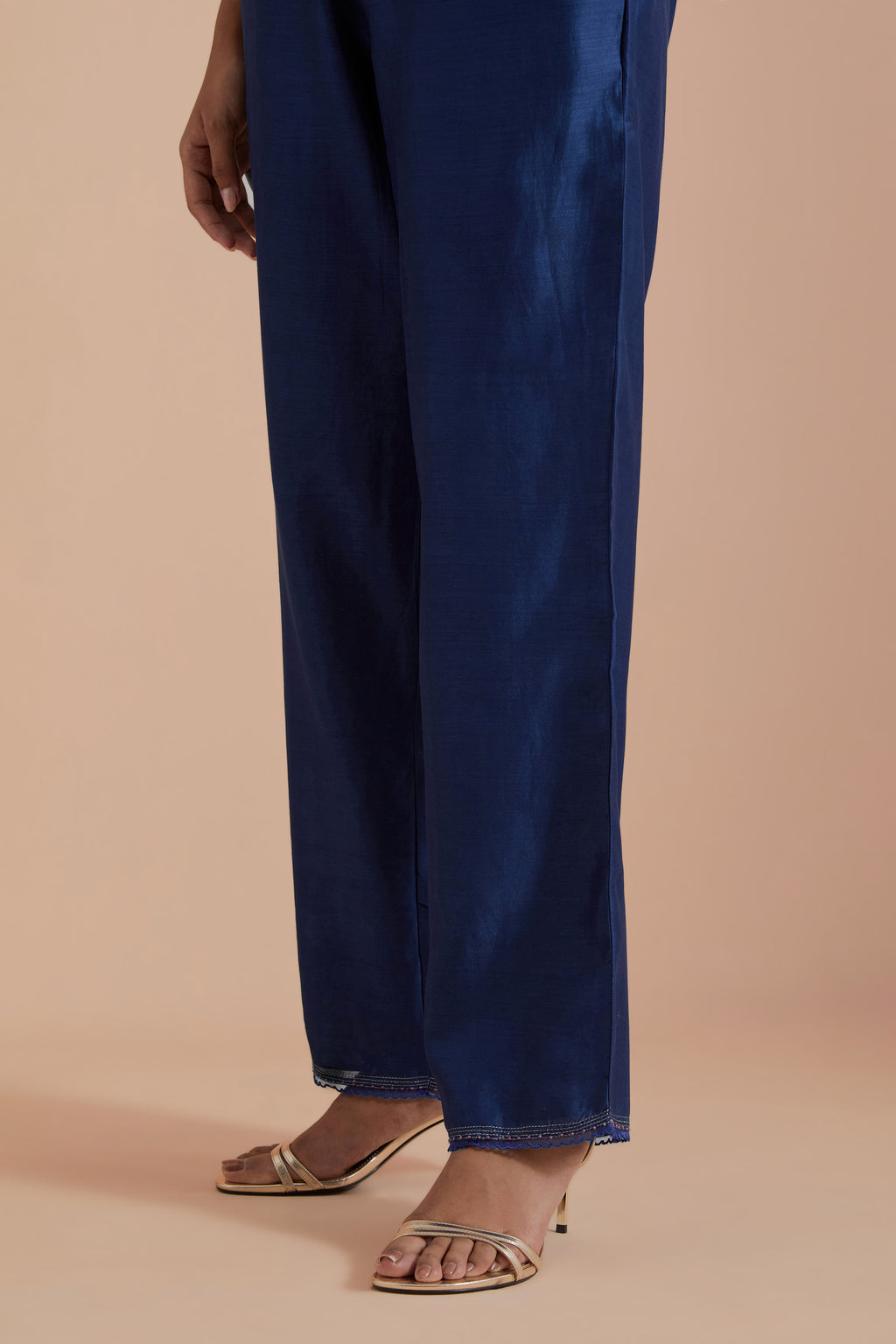 Blue silk chanderi straight pants detailed with scalloped organza edging at the hem, delicately highlighted with gold zari quilting.