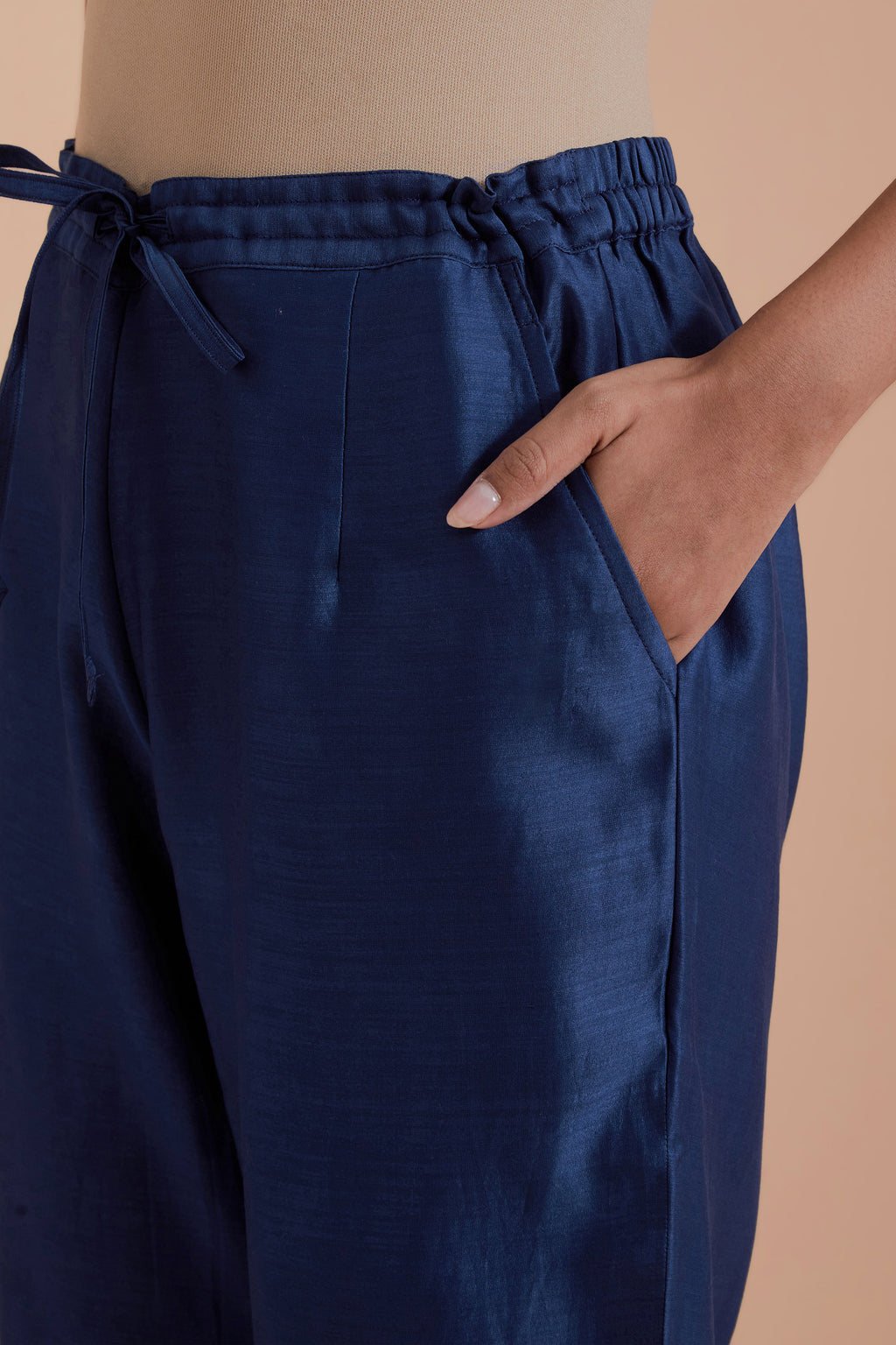 Blue silk chanderi straight pants detailed with scalloped organza edging at the hem, delicately highlighted with gold zari quilting.