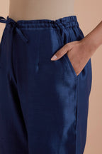Blue silk chanderi straight pants detailed with scalloped organza edging at the hem, delicately highlighted with gold zari quilting.
