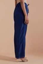 Blue silk chanderi straight pants detailed with scalloped organza edging at the hem, delicately highlighted with gold zari quilting.