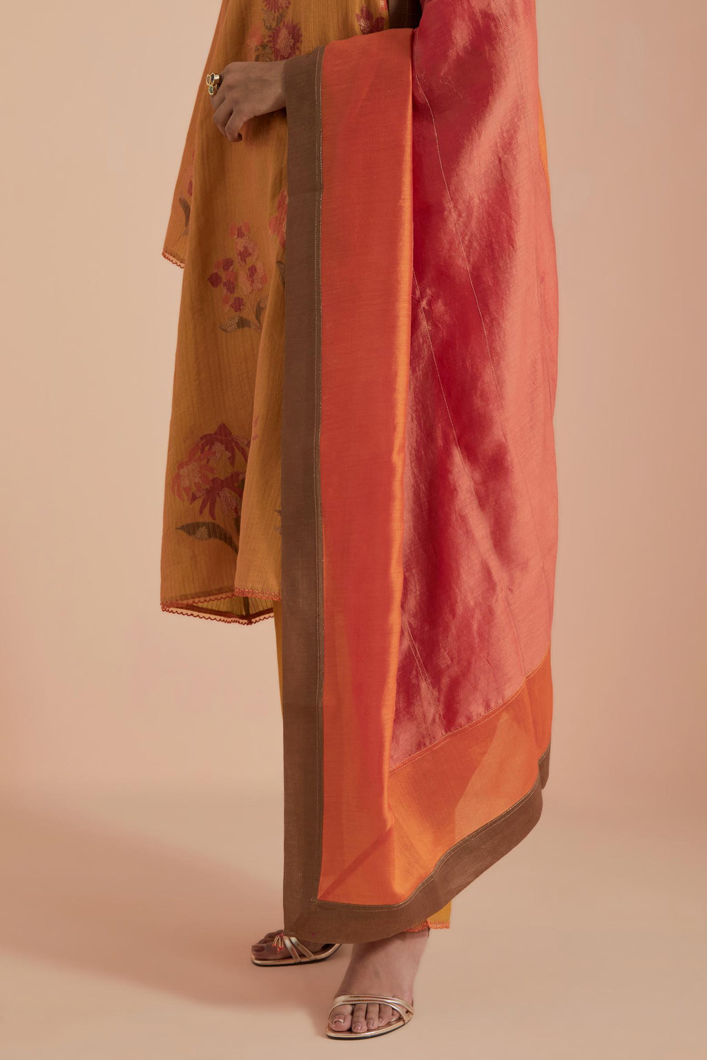 A silk chanderi three-tone dupatta in a beautiful gradient effect featuring delicate golden zari quilting all over.