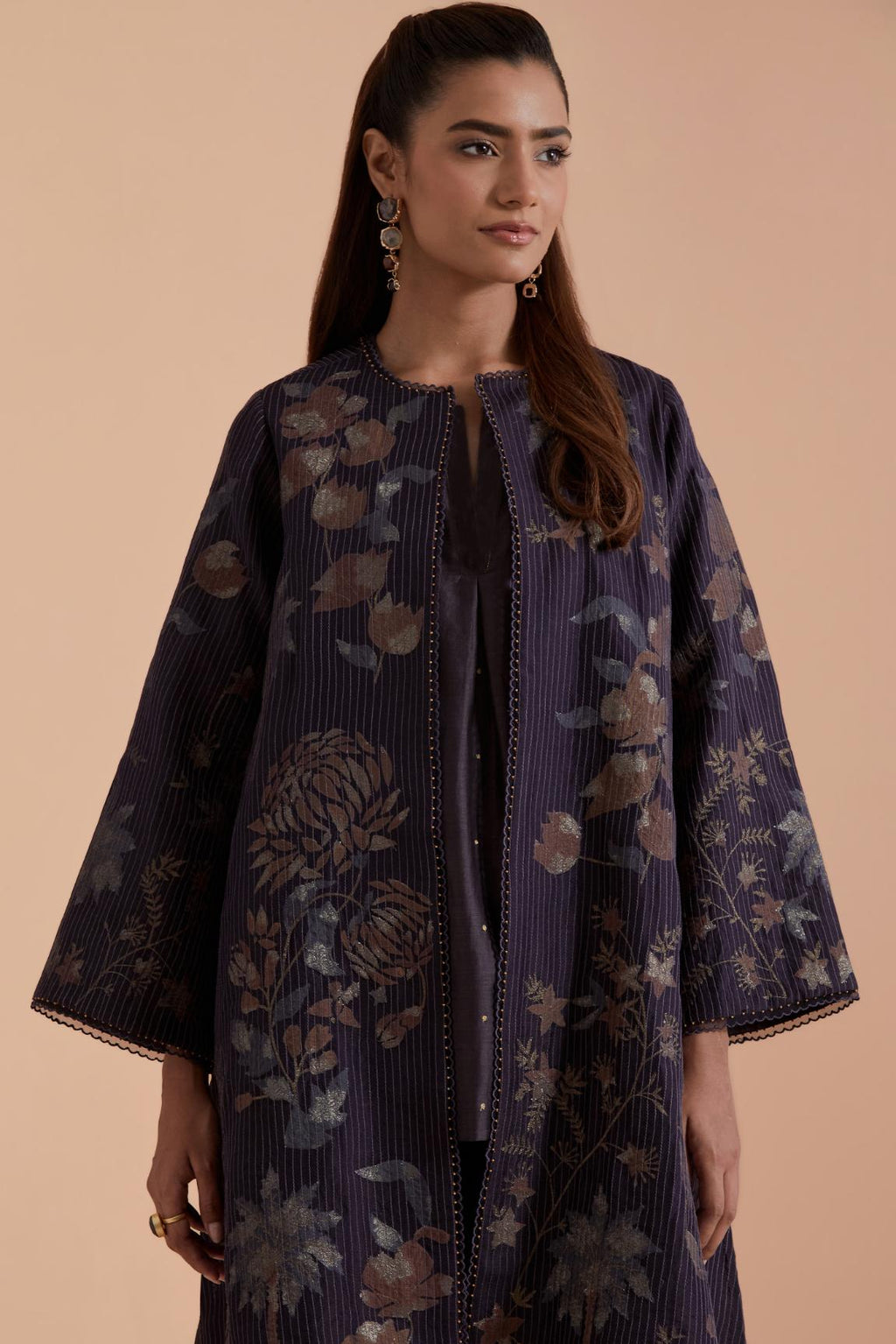 Dark grey short front open A-line jacket set layered with quilted Silk Organza and delicate Silk Brocade floral appliquéd bootas. Paired with dark grey silk chanderi straight pants