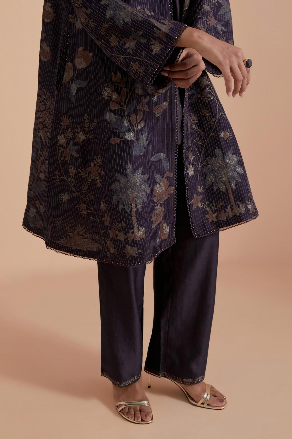 Dark grey short front open A-line jacket set layered with quilted Silk Organza and delicate Silk Brocade floral appliquéd bootas. Paired with dark grey silk chanderi straight pants