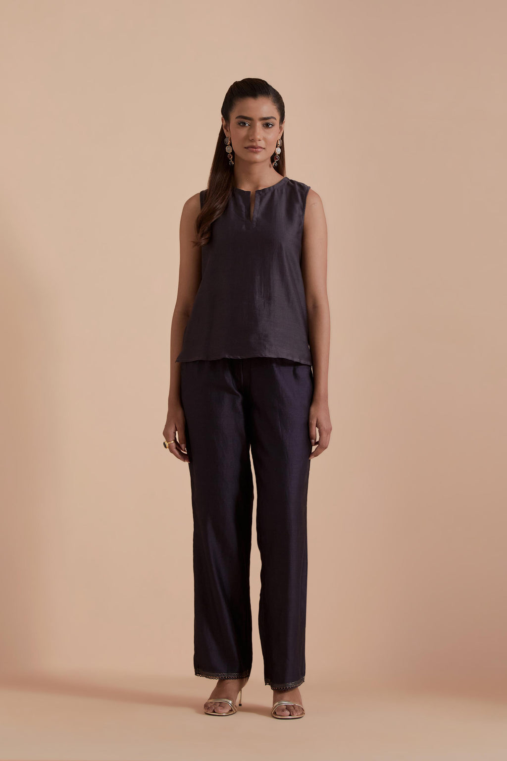 A Dark grey silk Chanderi jacket layered with quilted Silk Organza and delicate Silk Brocade floral appliquéd bootas. Paired with Dark grey silk chanderi straight pants.