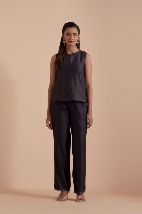 A Dark grey silk Chanderi jacket layered with quilted Silk Organza and delicate Silk Brocade floral appliquéd bootas. Paired with Dark grey silk chanderi straight pants.