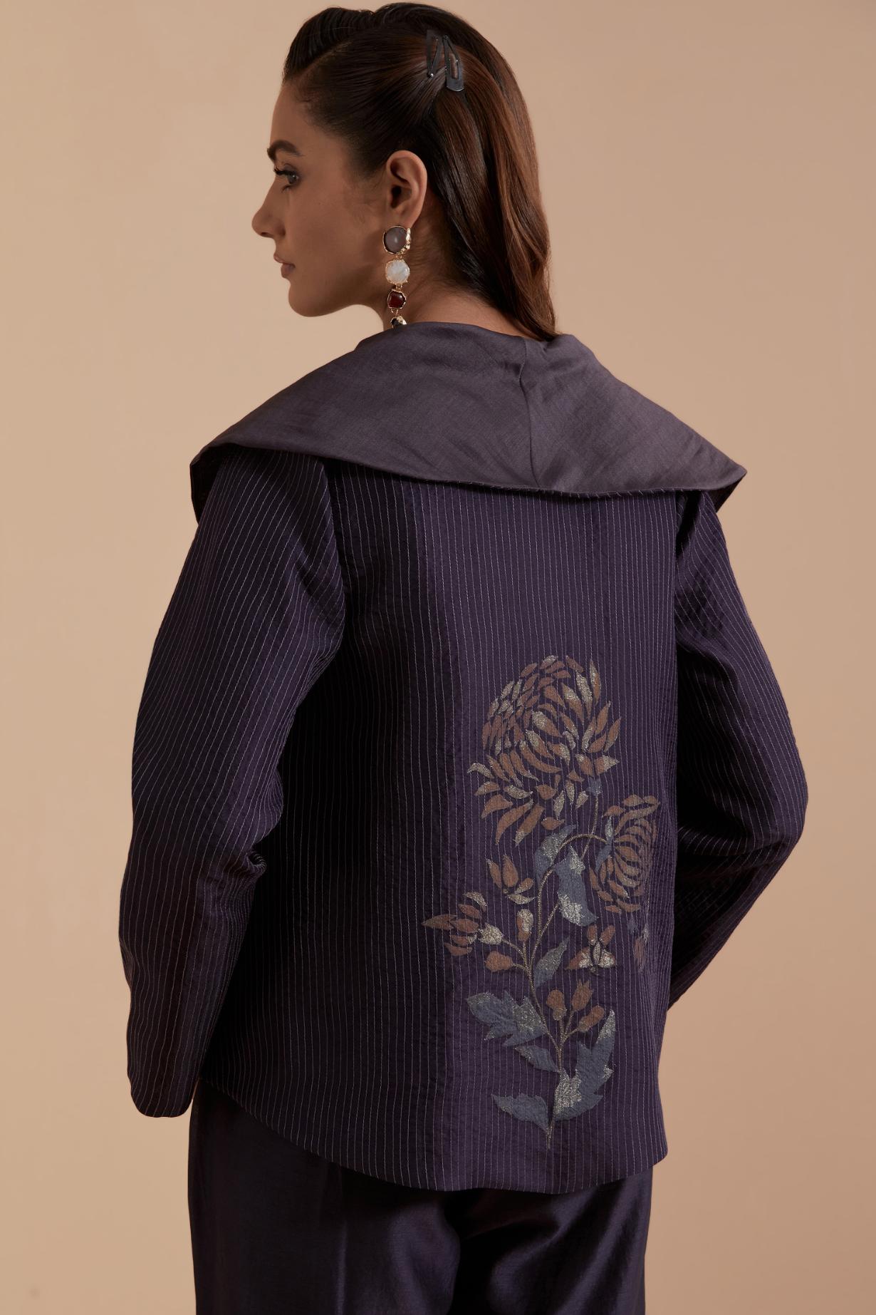 A Dark grey silk Chanderi jacket layered with quilted Silk Organza and delicate Silk Brocade floral appliquéd bootas. Paired with Dark grey silk chanderi straight pants.