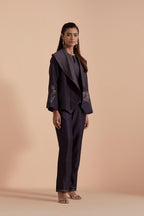 A Dark grey silk Chanderi jacket layered with quilted Silk Organza and delicate Silk Brocade floral appliquéd bootas. Paired with Dark grey silk chanderi straight pants.
