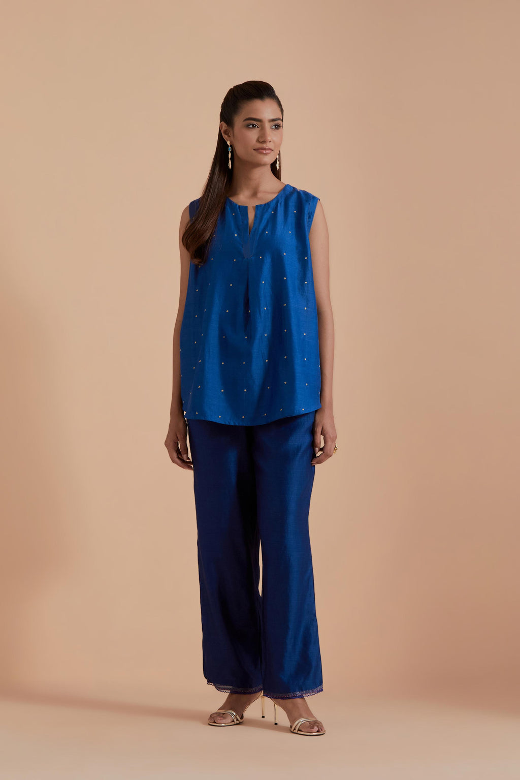 Blue short front open A-line jacket set layered with quilted Silk Organza and delicate Silk Brocade floral appliquéd bootas. Paired with Blue silk chanderi straight pants