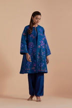 Blue short front open A-line jacket set layered with quilted Silk Organza and delicate Silk Brocade floral appliquéd bootas. Paired with Blue silk chanderi straight pants