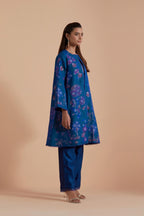 Blue short front open A-line jacket set layered with quilted Silk Organza and delicate Silk Brocade floral appliquéd bootas. Paired with Blue silk chanderi straight pants