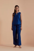 A Blue silk Chanderi jacket layered with quilted Silk Organza and delicate Silk Brocade floral appliquéd bootas. Paired with Blue silk chanderi straight pants.