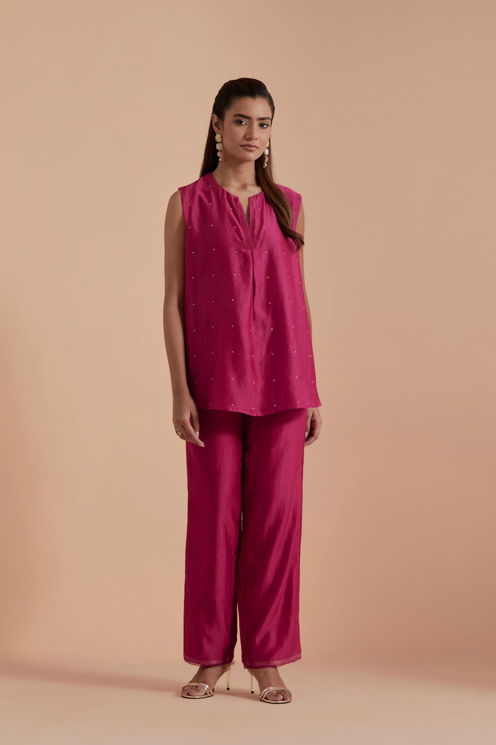 Fuchsia short front open A-line jacket set layered with quilted Silk Organza and delicate Silk Brocade floral appliquéd bootas. Paired with fuchsia silk chanderi straight pants.