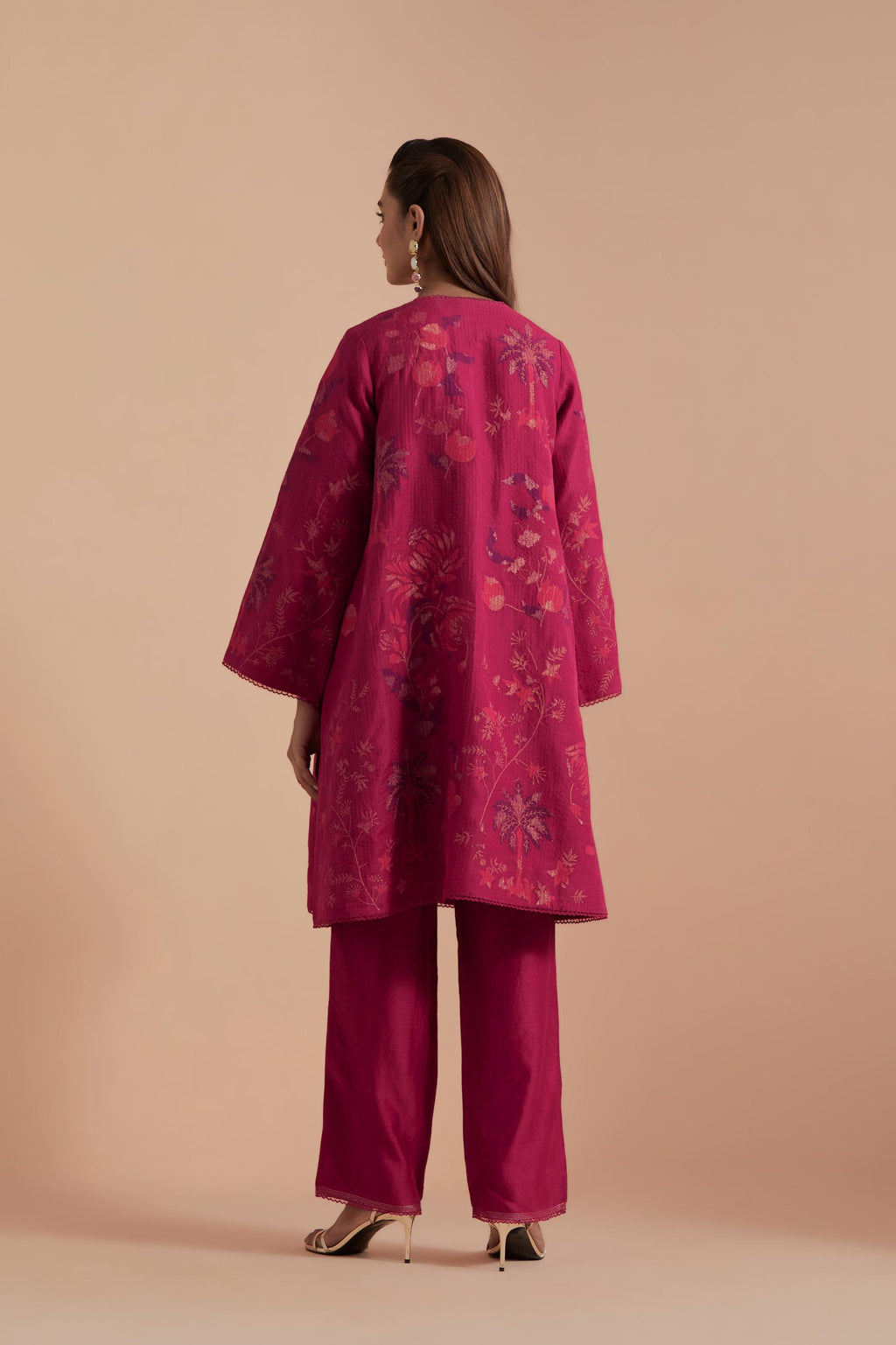 Fuchsia short front open A-line jacket set layered with quilted Silk Organza and delicate Silk Brocade floral appliquéd bootas. Paired with fuchsia silk chanderi straight pants.
