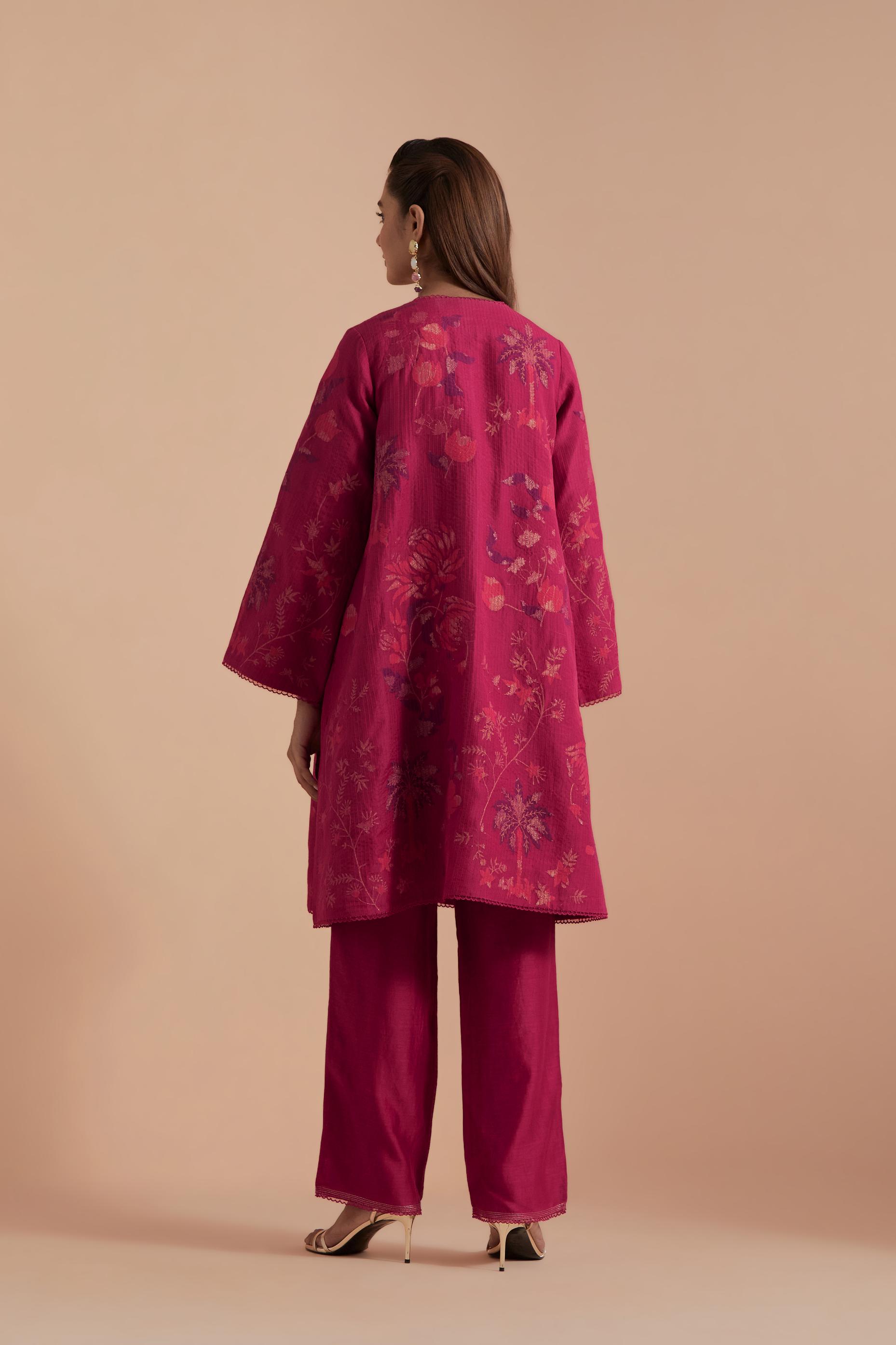 Fuchsia short front open A-line jacket set layered with quilted Silk Organza and delicate Silk Brocade floral appliquéd bootas. Paired with fuchsia silk chanderi straight pants.
