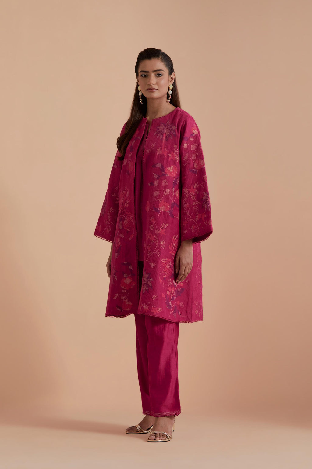 Fuchsia short front open A-line jacket set layered with quilted Silk Organza and delicate Silk Brocade floral appliquéd bootas. Paired with fuchsia silk chanderi straight pants.