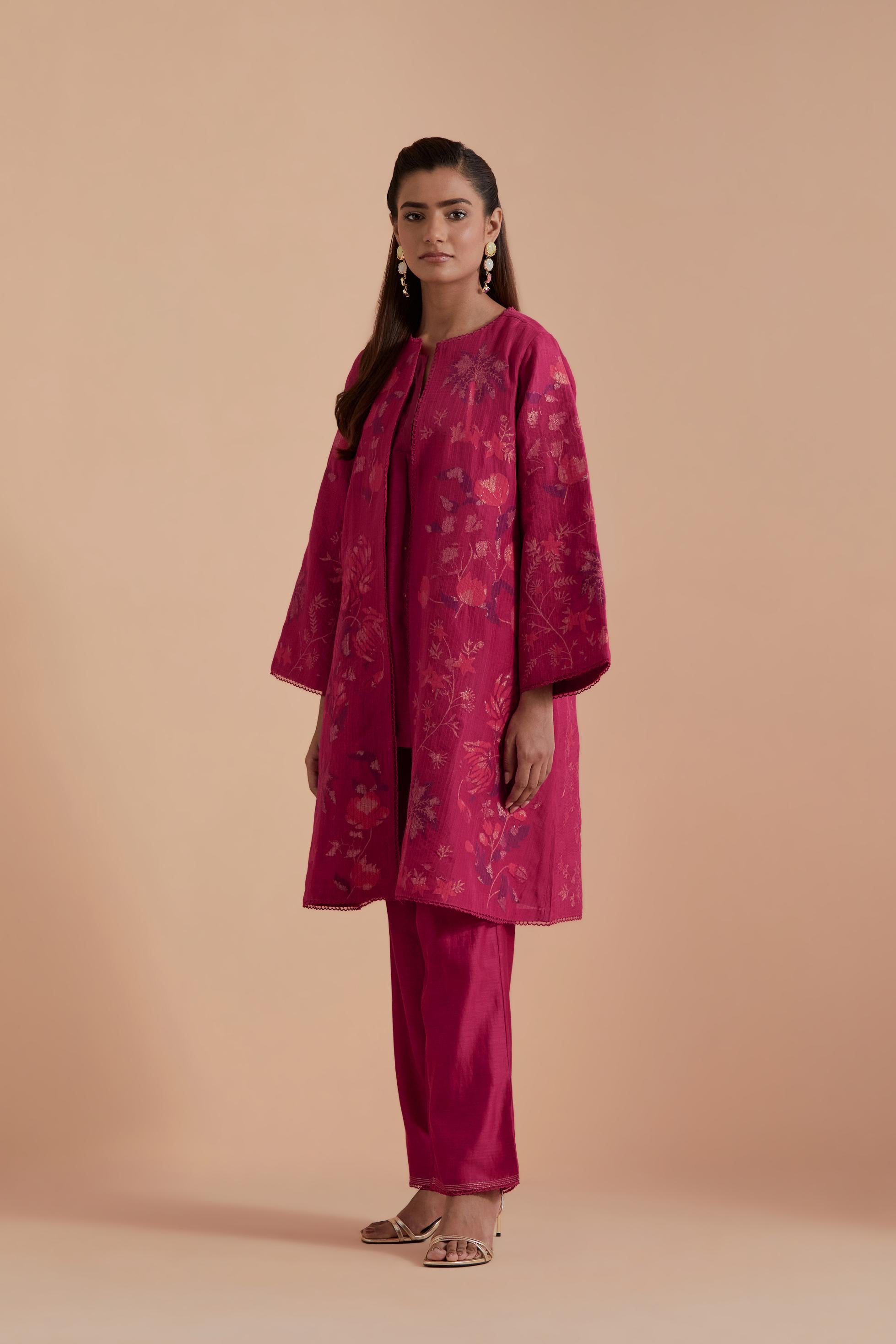 Fuchsia short front open A-line jacket set layered with quilted Silk Organza and delicate Silk Brocade floral appliquéd bootas. Paired with fuchsia silk chanderi straight pants.
