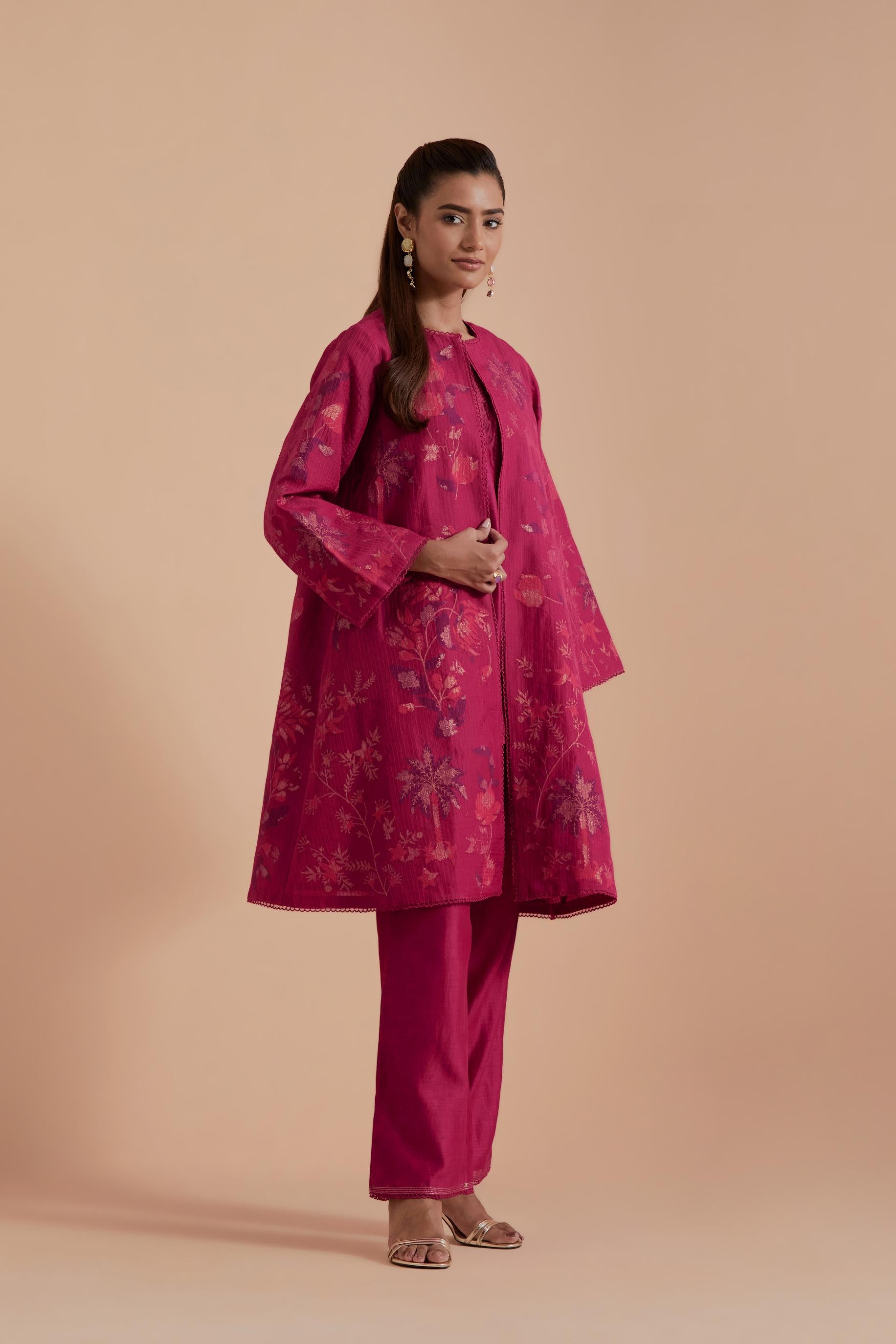 Fuchsia short front open A-line jacket set layered with quilted Silk Organza and delicate Silk Brocade floral appliquéd bootas. Paired with fuchsia silk chanderi straight pants.