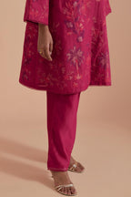 Fuchsia short front open A-line jacket set layered with quilted Silk Organza and delicate Silk Brocade floral appliquéd bootas. Paired with fuchsia silk chanderi straight pants.