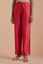 Orange silk chanderi straight pants detailed with scalloped organza edging at the hem, delicately highlighted with gold zari quilting.