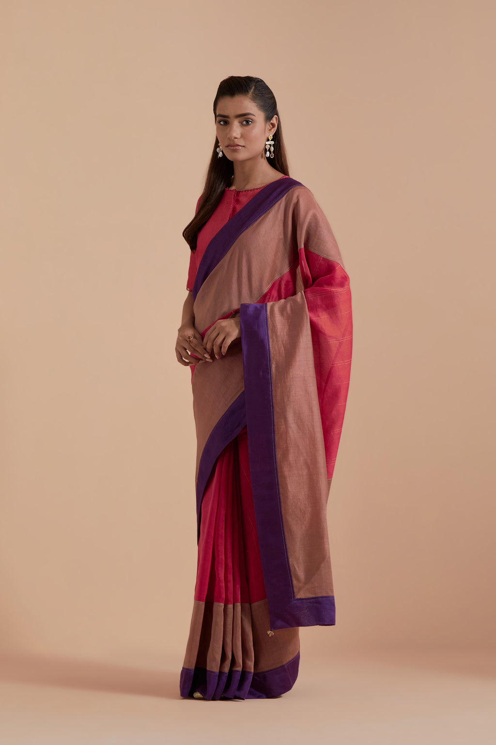 A silk Chanderi three-tone Carrot pink saree in a beautiful gradient effect featuring delicate golden zari quilting all over. Paired with Carrot pink silk Chanderi Quilted Organza & Brocade Floral Appliqué blouse.