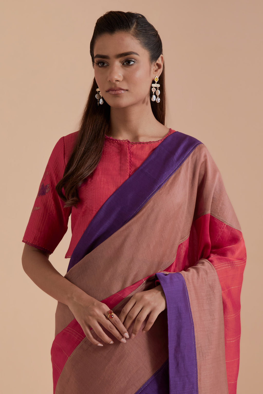 A silk Chanderi three-tone Carrot pink saree in a beautiful gradient effect featuring delicate golden zari quilting all over. Paired with Carrot pink silk Chanderi Quilted Organza & Brocade Floral Appliqué blouse.