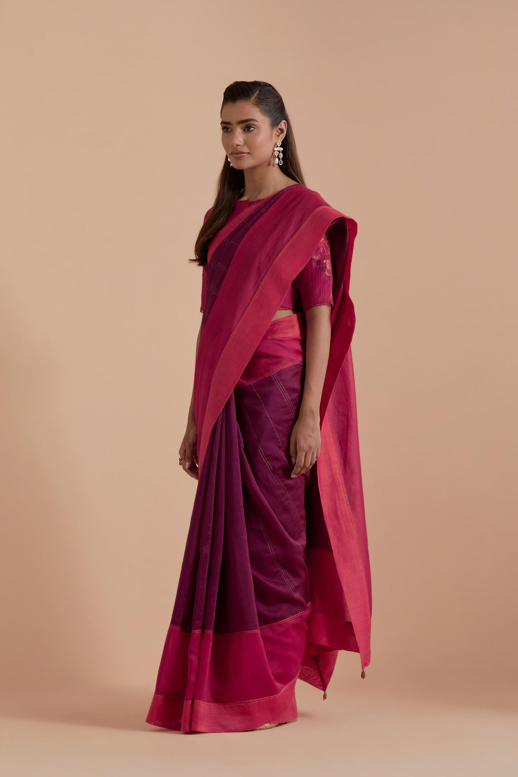 A silk Chanderi three-tone fuchsia saree in a beautiful gradient effect featuring delicate golden zari quilting all over. Paired with Fuchsia silk Chanderi Quilted Organza & Brocade Floral Appliqué blouse.