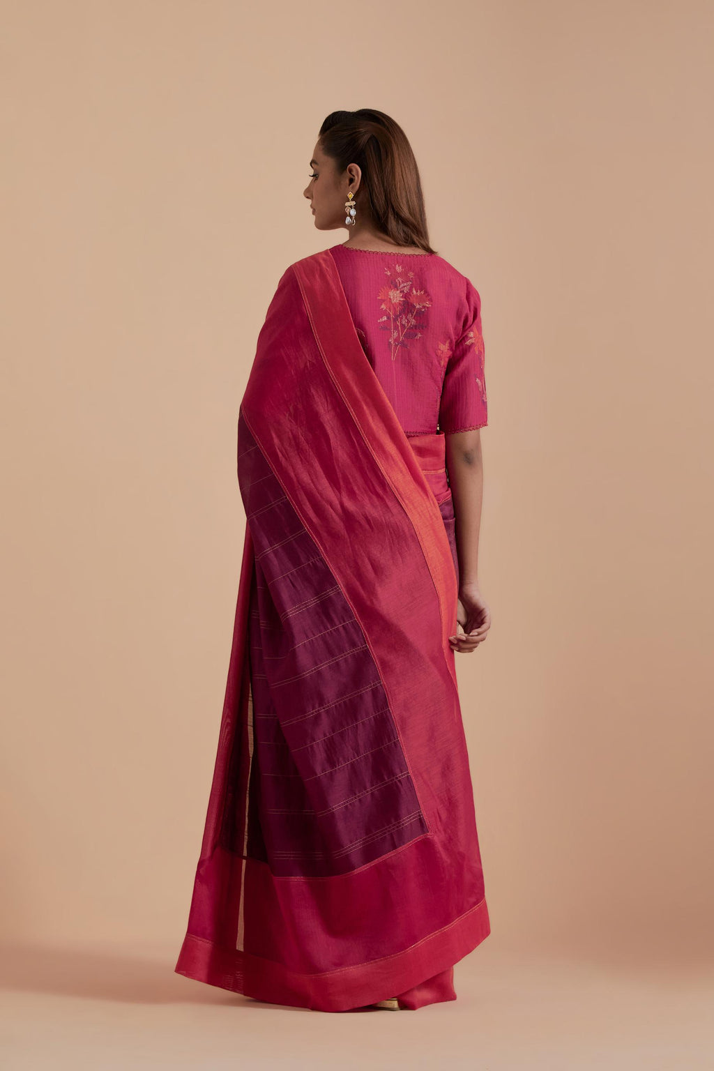 A silk Chanderi three-tone fuchsia saree in a beautiful gradient effect featuring delicate golden zari quilting all over. Paired with Fuchsia silk Chanderi Quilted Organza & Brocade Floral Appliqué blouse.