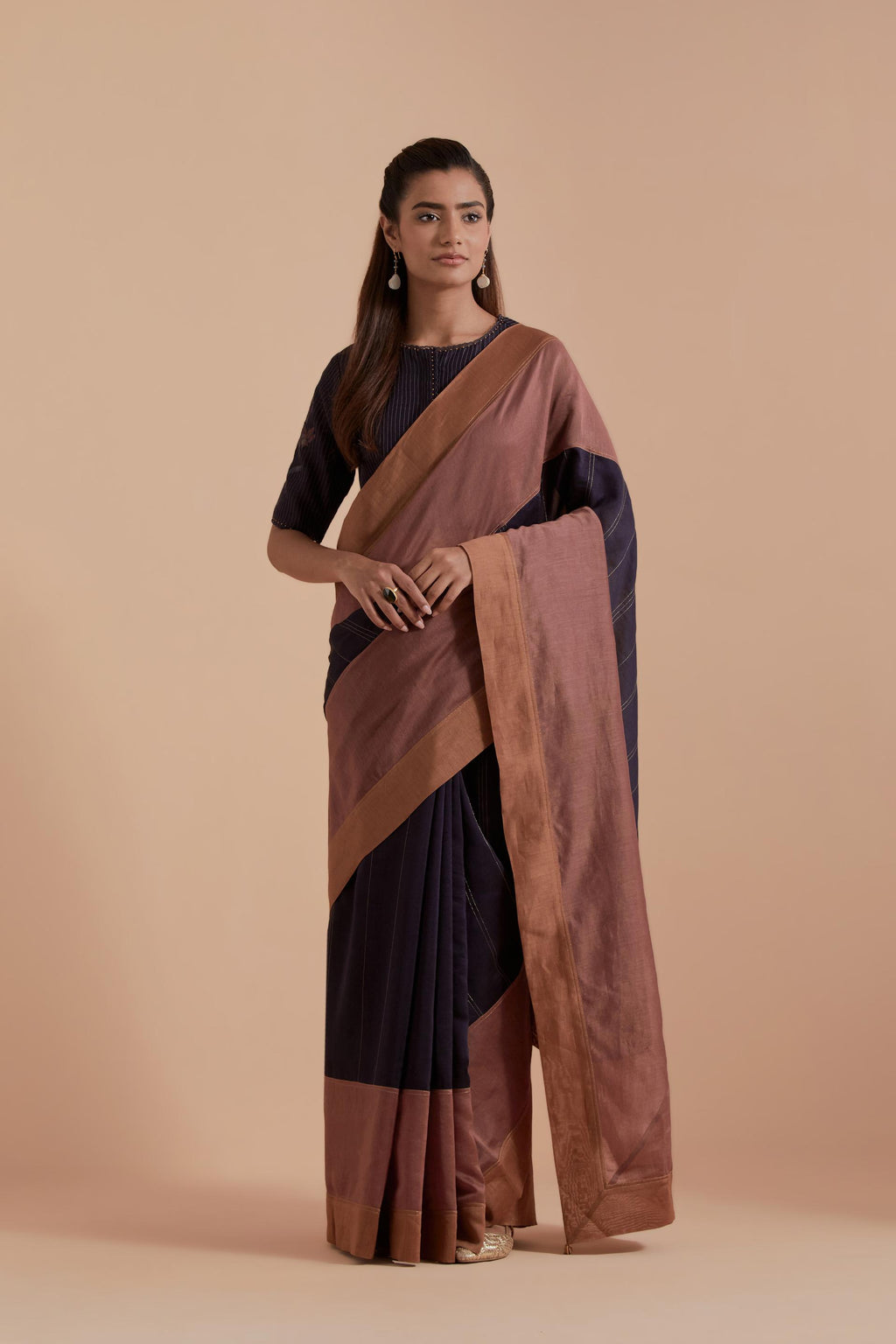 A silk Chanderi three-tone Dark Grey saree in a beautiful gradient effect featuring delicate golden zari quilting all over. Paired with Dark Grey silk Chanderi Quilted Organza & Brocade Floral Appliqué blouse.