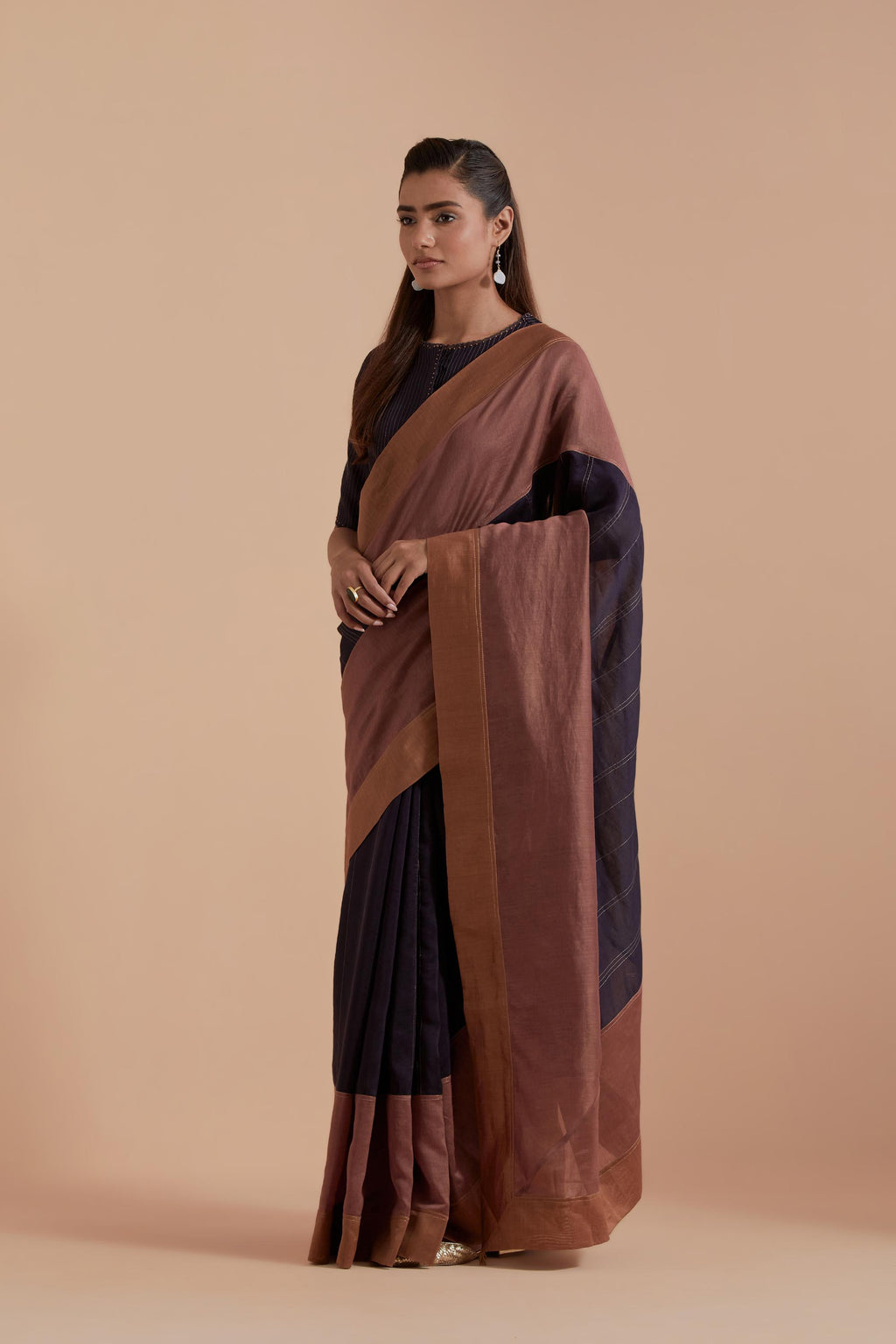 A silk Chanderi three-tone Dark Grey saree in a beautiful gradient effect featuring delicate golden zari quilting all over. Paired with Dark Grey silk Chanderi Quilted Organza & Brocade Floral Appliqué blouse.