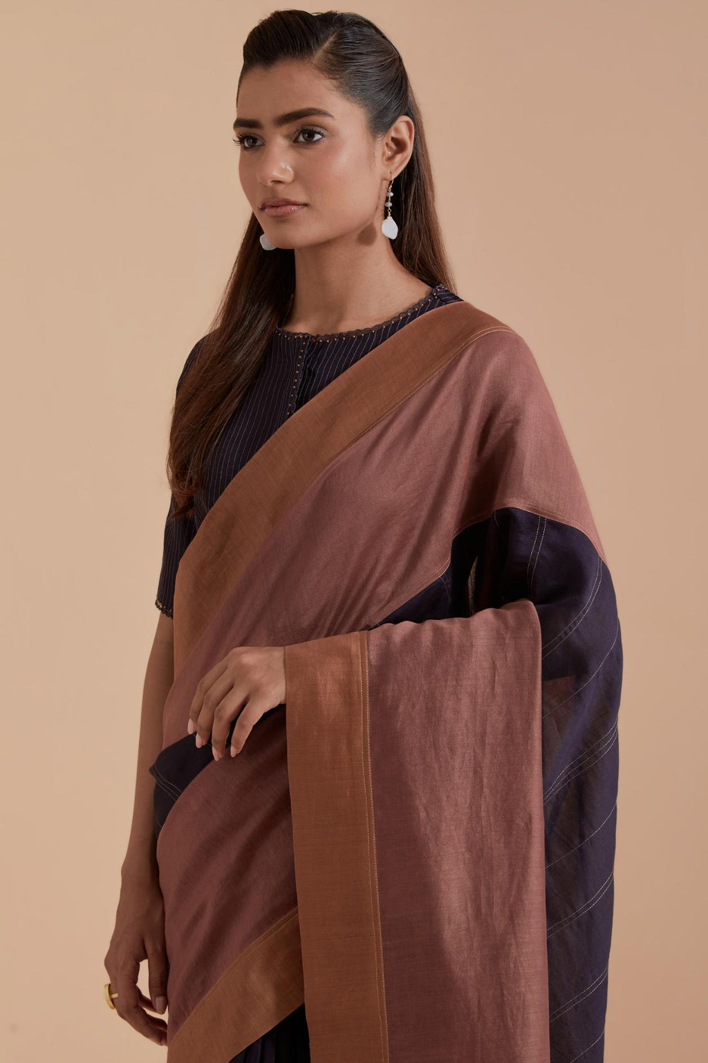 A silk Chanderi three-tone Dark Grey saree in a beautiful gradient effect featuring delicate golden zari quilting all over. Paired with Dark Grey silk Chanderi Quilted Organza & Brocade Floral Appliqué blouse.