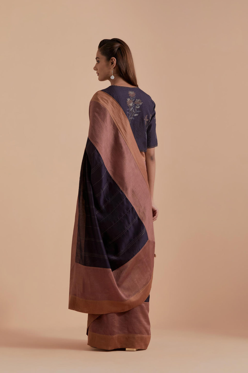 A silk Chanderi three-tone Dark Grey saree in a beautiful gradient effect featuring delicate golden zari quilting all over. Paired with Dark Grey silk Chanderi Quilted Organza & Brocade Floral Appliqué blouse.
