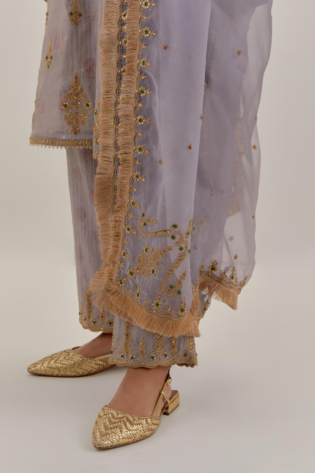 Lilac silk organza dupatta detailed with all-over light gold dori embroidery, highlighted with multi colored beads & gold sequins.